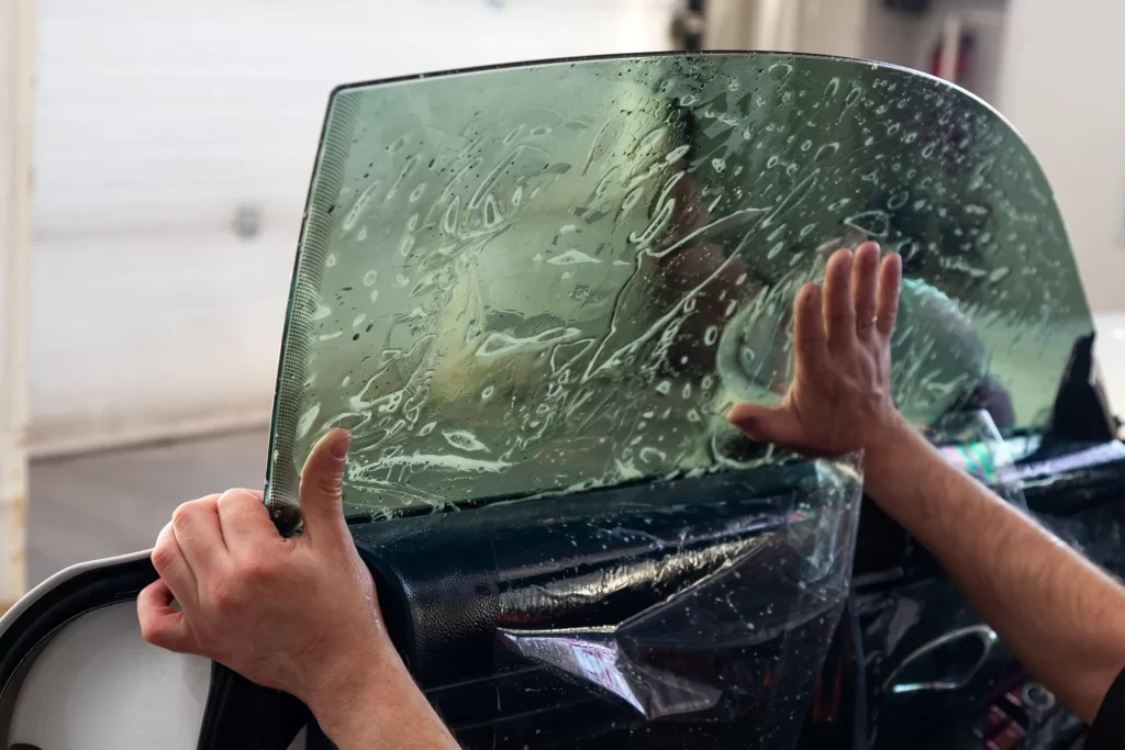 Window Tint being installed on a vehicle's window