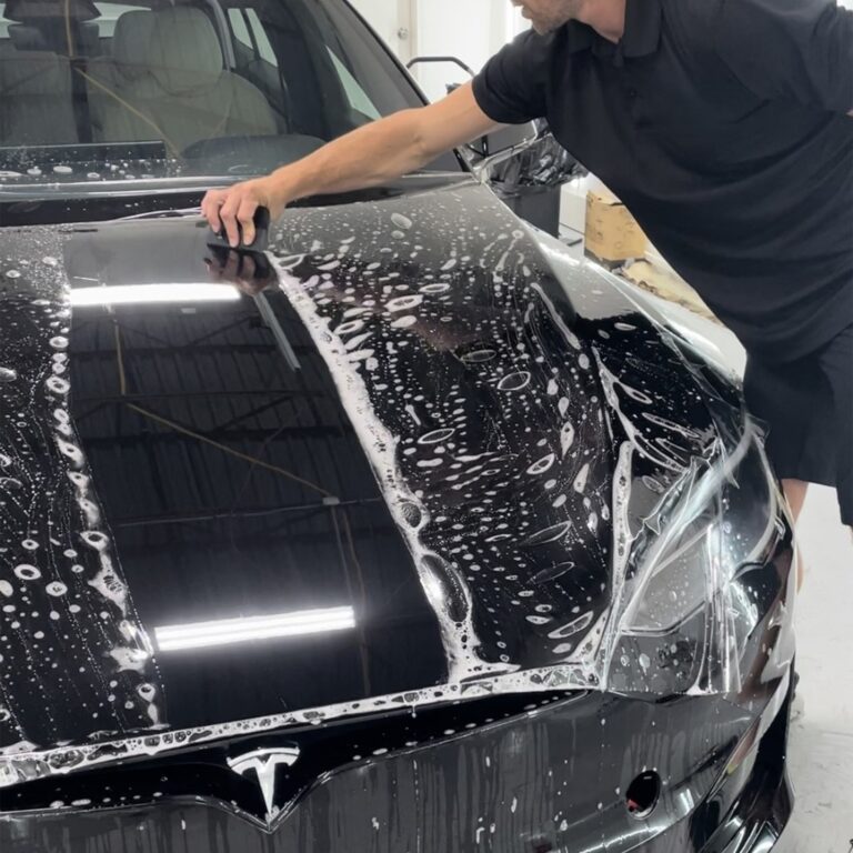 Paint Protection Film (PPF) installation being done on a vehicle's Hood